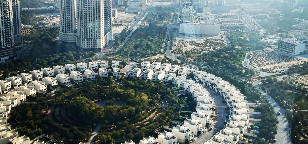 Modern residential building and park area in JVC Dubai